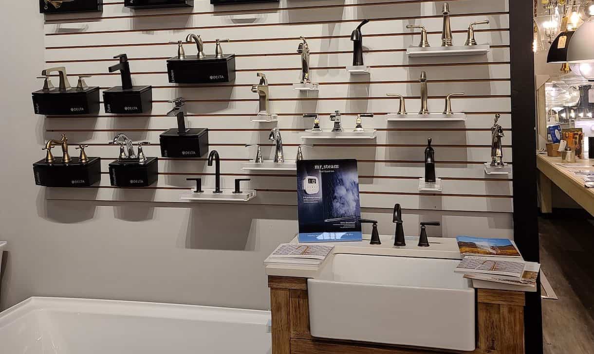 Showroom display of sink faucets, and bathtub