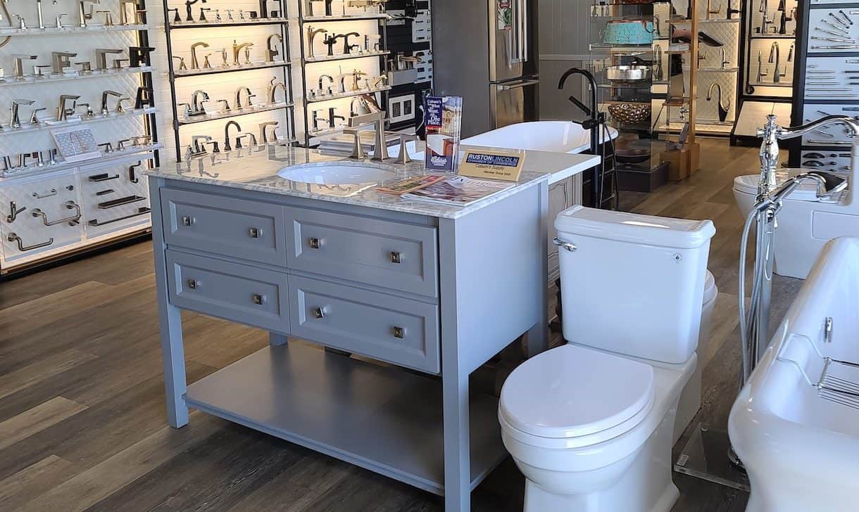 Showroom display featuring toilet, cabinet & hardware, and faucets