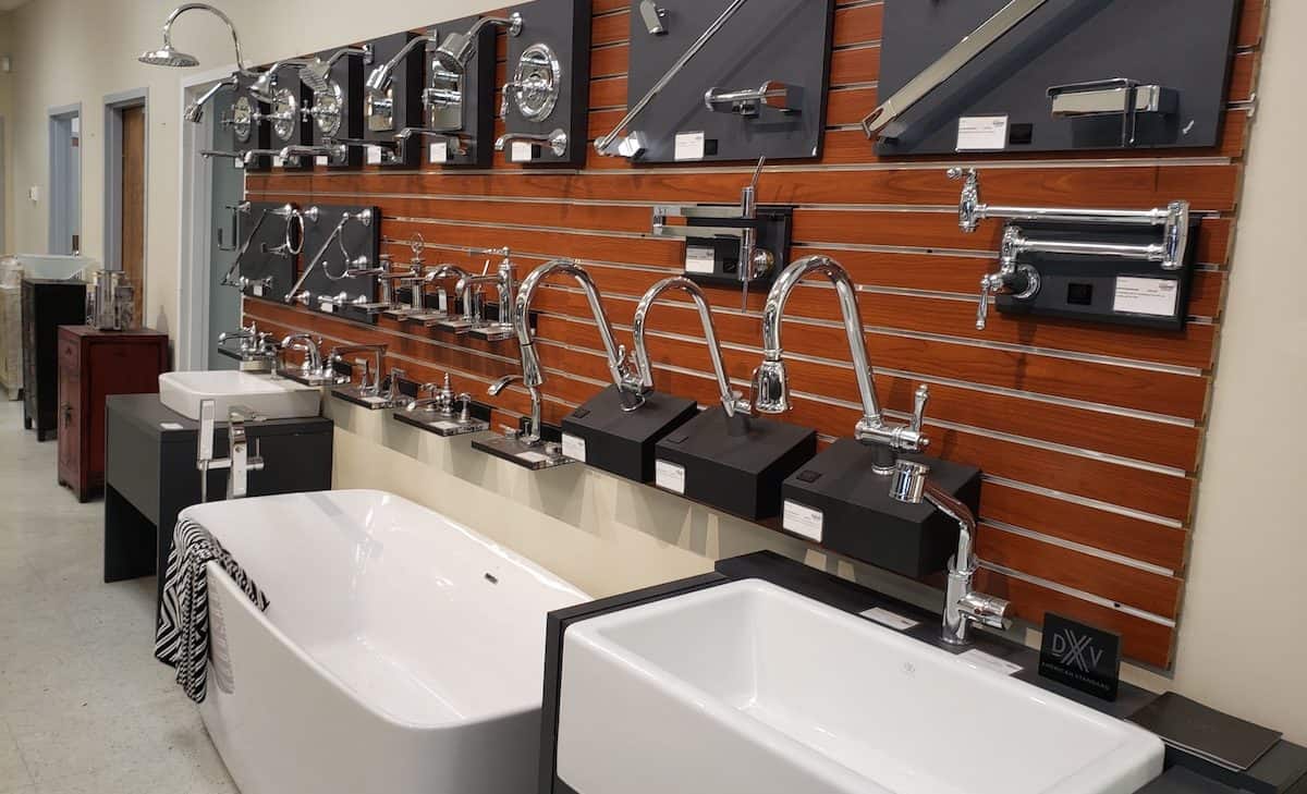 Showroom display featuring bathtubs and sink faucets