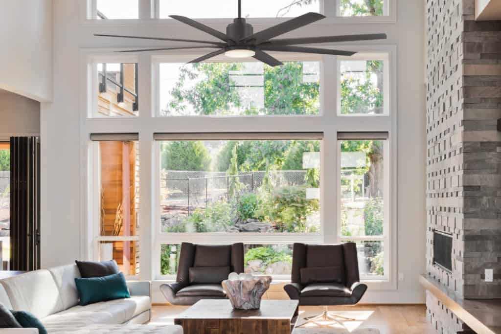 contemporary interior design style image featuring a modern living space with large windows, sleek furniture, and neutral tones