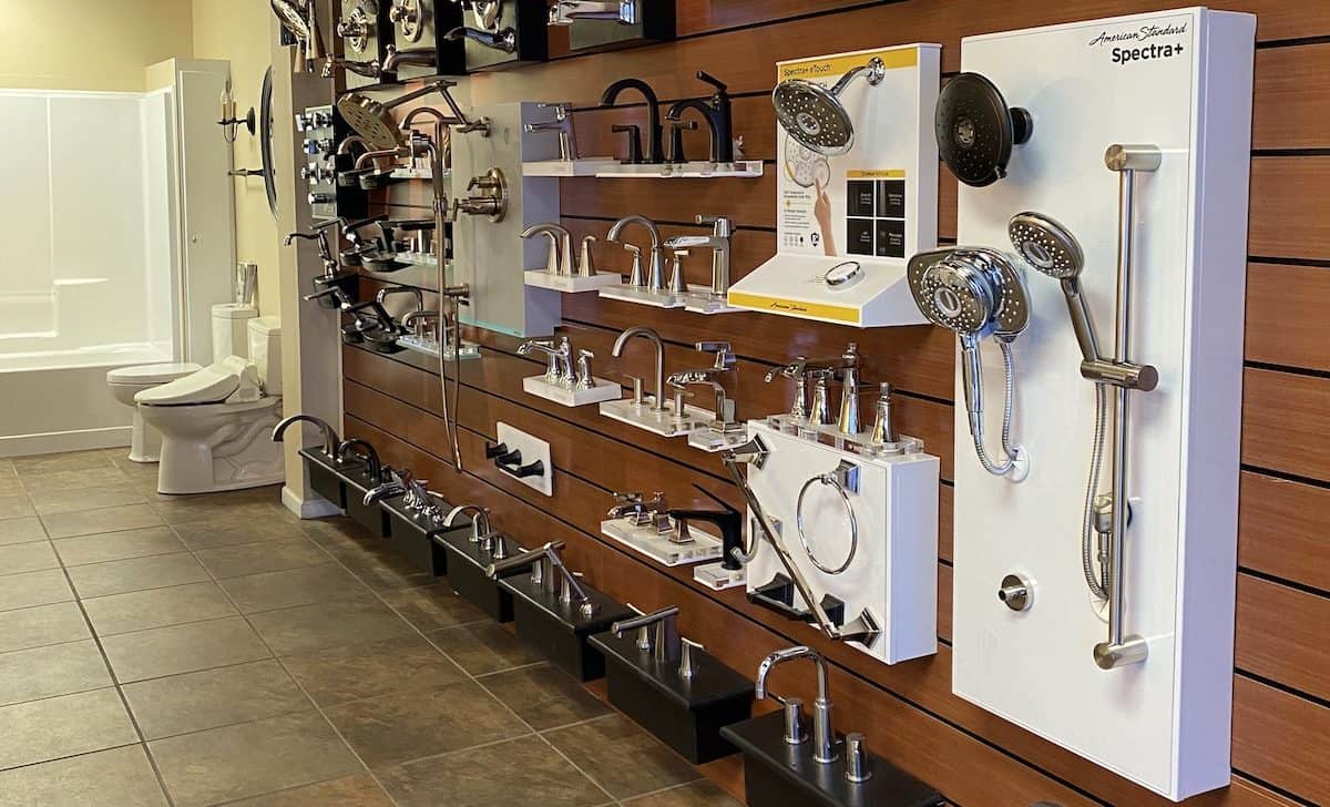 Display wall featuring shower heads, and sink faucets