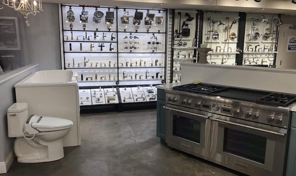 Showroom display featuring oven, toilet, bathtub, and faucets