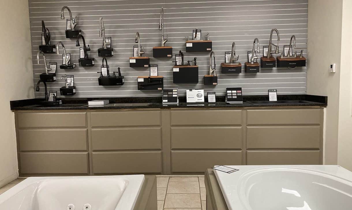 Sink faucet display with countertops and bathtub