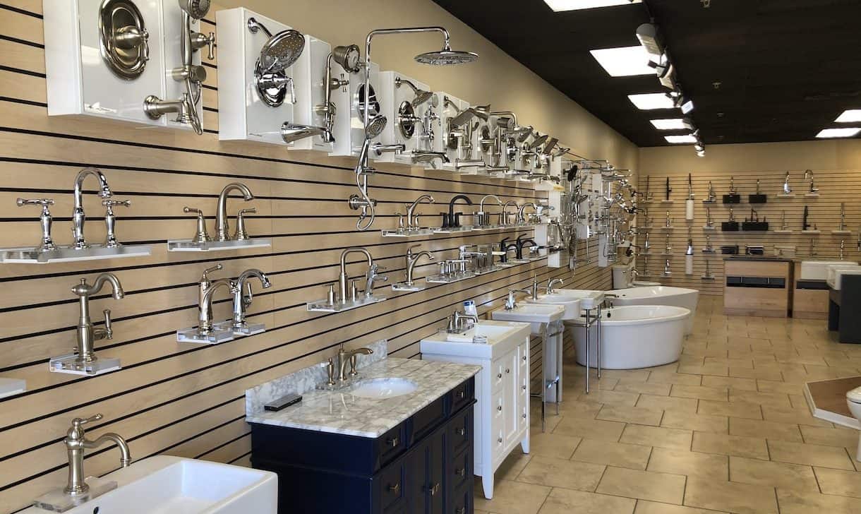 Showroom display featuring sinks, faucets, and shower heads