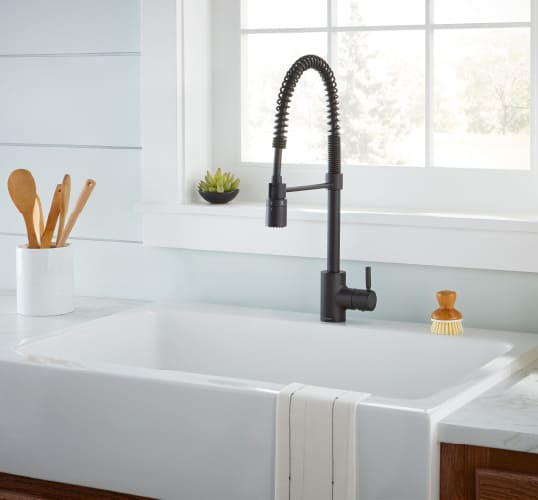 the pop of this matte black faucet against the white sink and baby blue walls offers the perfect kitchen design inspiration for all fans of the bold