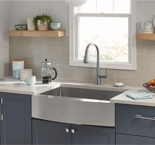 a homey kitchen featuring a stainless steel basin sink. Get more kitchen design inspiration at Coburn's Kitchen & Bath Showroom