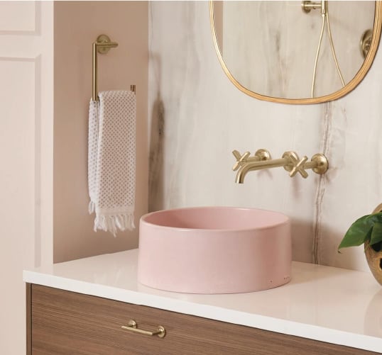 A pink vessel sink adorned with gold fixtures and surrounded by marble and gold accents make for the perfect bathroom inspiration for anyone romantic at heart.