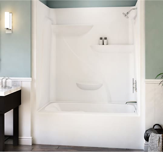 A 2-in-1 alcove bathtub and shower with white surrounds accented by light blue walls and white paneling. This space offers the perfect bathroom renovation inspiration to fans of the traditional style.