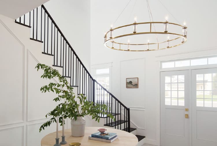 Modern foyer design ideas from Coburn’s Showroom. Featuring a round pendant light, sleek decor and foliage for a pop of color.