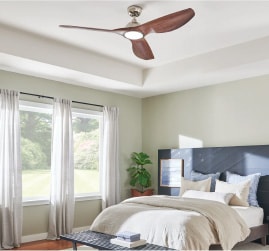 Interesting ceiling fans to fuel your bedroom design ideas and inspiration. Featuring a wooden ceiling fan with curved blades within a modern bedroom setting.