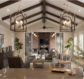 Transitional lighting options for your next living room remodel project. Featuring caged chandeliers with faux candle-stick lighting within a transitional living room setting.