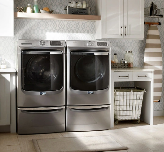 Small space laundry room design ideas, featuring a matching front load washer and dryer set in light gray.