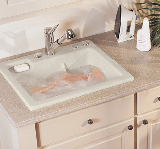 A small space laundry room design featuring a laundry room sink perfect for presoaking and handwashing.