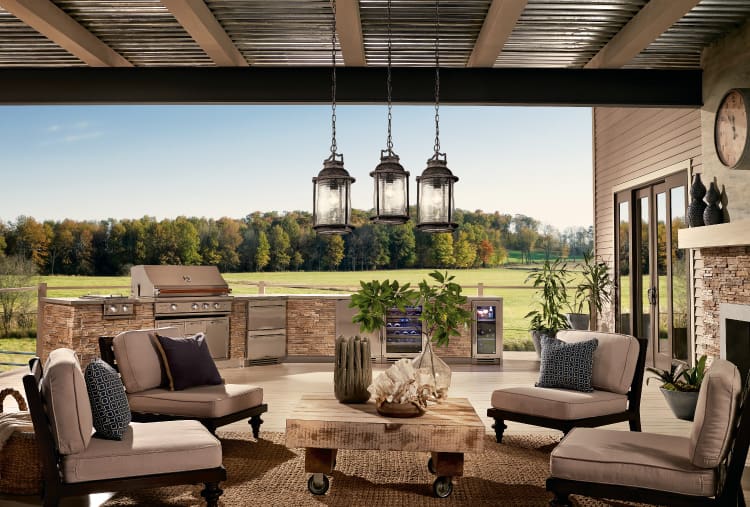 An outdoor entertainment area featuring cozy seating and an outdoor cooking station. Get more DIY backyard ideas at a Coburn's Showroom near you.