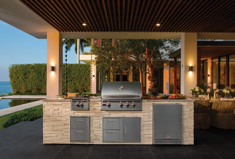 a grill built into an outdoor entertainment area