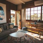 A modern living room design with a plush couch, a sleek coffee table, and a window that enhances the space with light.