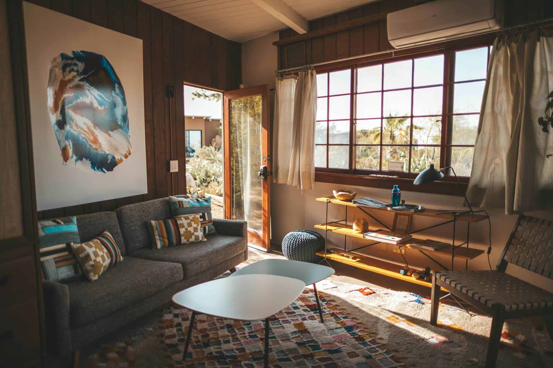 A modern living room design with a plush couch, a sleek coffee table, and a window that enhances the space with light.