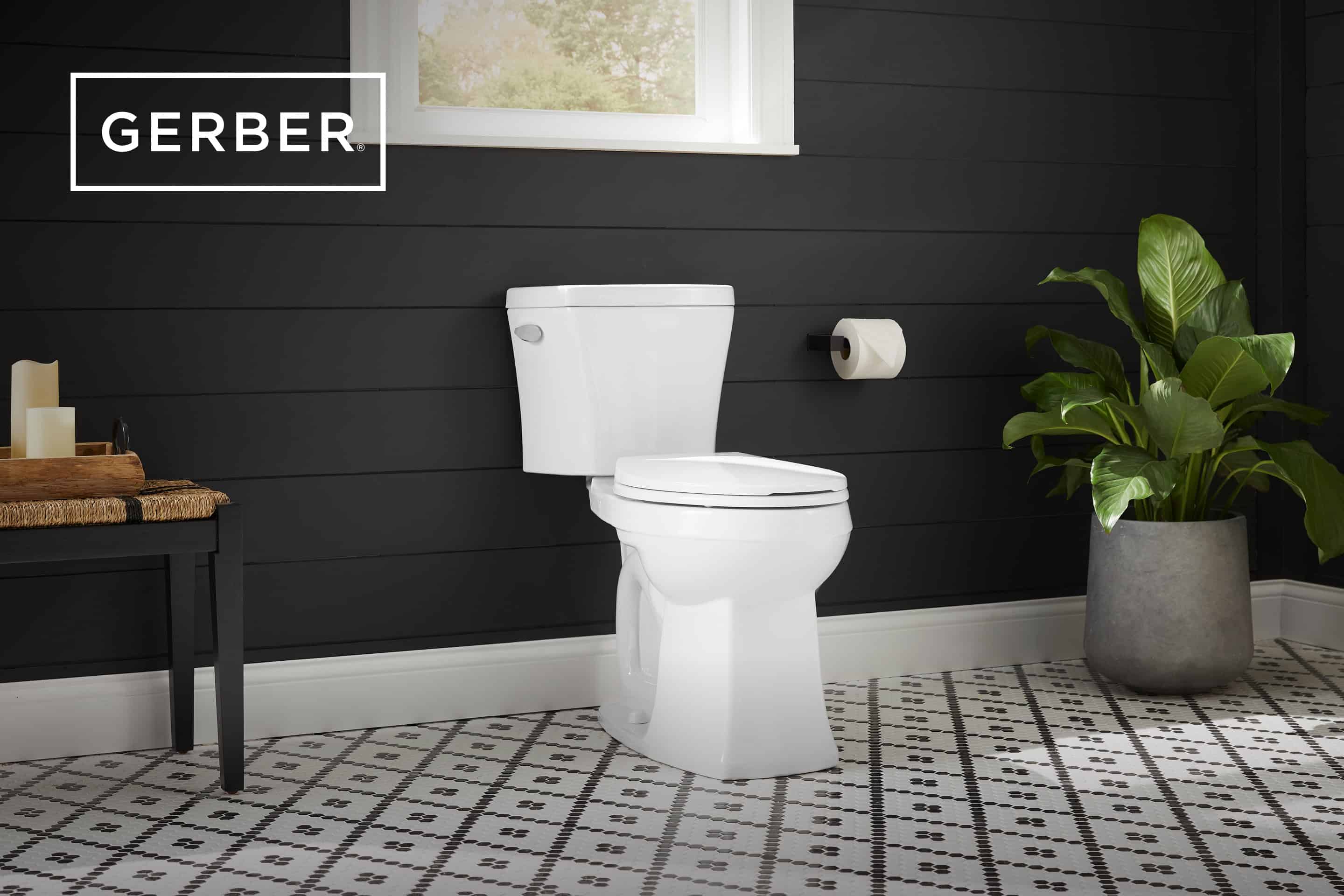 Modern bathroom featuring a Gerber white toilet against a black shiplap wall